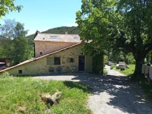 a building with a garage in front of it at Gîte à la campagne in Laborel
