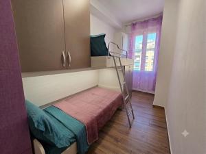 a small room with a bunk bed and a ladder at Appartamento LIBERTA, Liguria in Rapallo