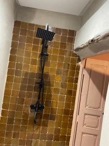 a bathroom with a light on the floor next to a door at Riad Marrakech Palacito in Marrakesh