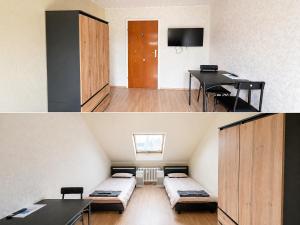 a small room with two beds and a table at Kurzzeitvermitung Angelov in Hameln