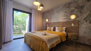 a bedroom with a bed and a large window at Domaine Lantana in Porto-Vecchio +118 photos