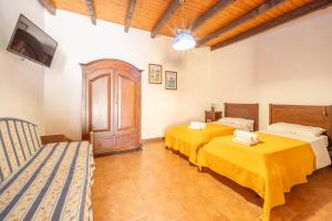two beds in a room with a tv and a couch at Hotel Al Togo Fitness & Relax in Vulcano +134 photos