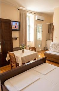 a living room with a table and a tv at Villa Parma in Maribor Self check - in in Maribor