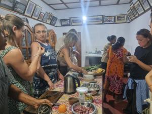 a group of women standing around a table preparing food at Ella Hidden Ferns in Ella