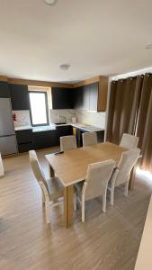 a kitchen with a table and chairs in a room at SunVillaTuzi in Tuzi