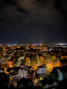 a view of a city at night with lights at Rania Penthouse 1 in Şelimbăr +4 photos