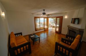 a living room with orange chairs and a fireplace at Primestay - Chalet Panamá - Piscina y Vistas al Castillo in Peniscola +31 photos