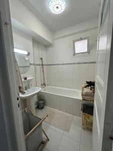 a bathroom with a bath tub and a sink at appartement cozy in Kolea +52 photos