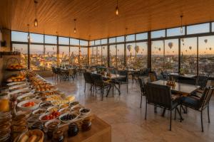 a dining room with a table with plates of food at Mai Cappadocia in Göreme