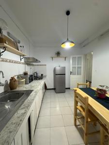a kitchen with a sink and a refrigerator at appartement cozy in Kolea