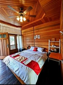 a bedroom with a bed with a ceiling fan at Hotel Besar Bulan Baru Senggigi - Near Senggigi Beach in Senggigi +85 photos