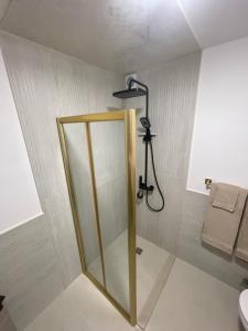 a shower with a glass door in a bathroom at SunVillaTuzi in Tuzi +16 photos