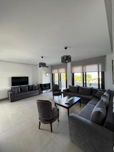 a large living room with couches and a table at Meintis Apartments Rafina in Rafina