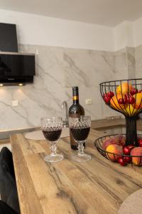 a table with two glasses of wine and a bowl of fruit at Stefanos House in Afitos +39 photos