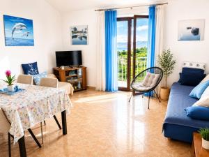 a living room with a table and a couch at Apartment RB in Omišalj