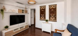 a living room with a flat screen tv on a wall at Vistas al castillo in Cullera