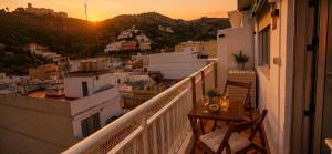 a balcony with a table and a view of a city at Vistas al castillo in Cullera