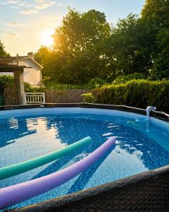 a swimming pool with colorful inflatables in a yard at Casa con piscina y jacuzzi in Pontevedra