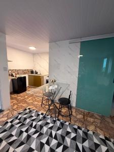 a glass table and chairs in a room at Refúgio 4 in Belo Horizonte