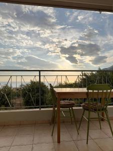 a table and chairs on a balcony with a view at Casa Boha Garden in Dhërmi