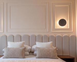 a bed with two pillows in a room at City Lights Apartments in Krakow