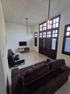 a living room with a couch and a television at Quarto Confortável no Centro - Bela Ilha House in São Luís