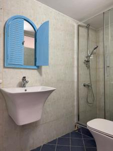 a bathroom with a sink and a shower with a mirror at Casa Boha Garden in Dhërmi +30 photos