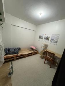 a room with a bed and a desk and a chair at CJ's Travellers Room in Maribago