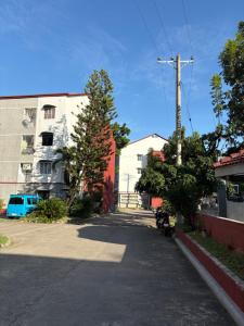 an empty street in a city with a building at CJ's Travellers Room in Maribago