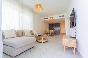 a living room with a couch and a table at Ayla Aqaba Azure 2 bedroom in Aqaba