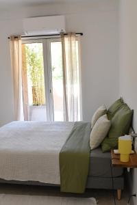 a bedroom with a bed and a large window at Résidence Gigaro plage in La Croix-Valmer