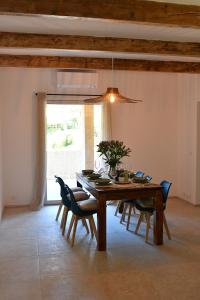 a dining room with a wooden table and chairs at Résidence Gigaro plage in La Croix-Valmer +3 photos
