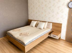 a small bedroom with a bed with a clock on the wall at Modi Line Vee in Valga
