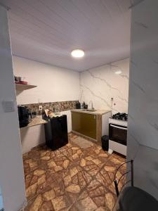 a kitchen with a counter and a sink and a stove at Refúgio 4 in Belo Horizonte +21 photos