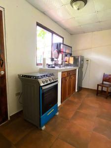 a kitchen with a stove and a counter top at La Villa Study & Relax Apartment in Los Santos