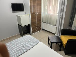 a hotel room with a bed and a tv and a room at LOTUS OTEL in Konya
