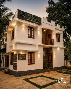 a building with a sign that reads hr law auxiliary at Re-Leaf Hom-Treat Homestay in Wayanad