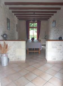 a dining room with a table and a window at laferme de chez Piché in Chérac