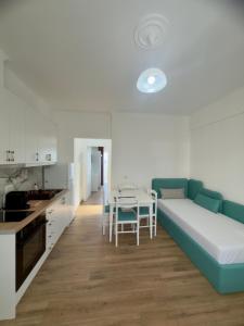 a living room with a couch and a table at The Gwen in Sarandë