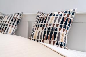 a bed with two pillows on top of it at Apartma BONUS in Begunje na Gorenjskem +7 photos