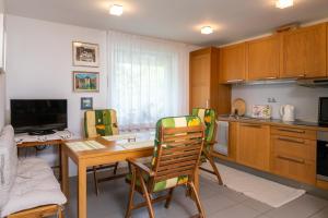 a kitchen with a table and chairs and a desk at Apartma BONUS in Begunje na Gorenjskem
