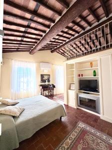a bedroom with a large bed and a fireplace at Antica Residenza Dell'Angelo in Lucca
