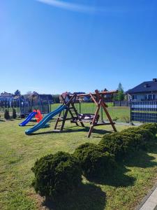 a playground with a slide in a park at Apartamenty NOVA - BLISKO ENERGYLANDII in Zator