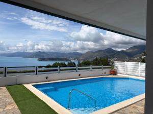 a swimming pool with a view of the water at Villa Max in San Nicola Arcella