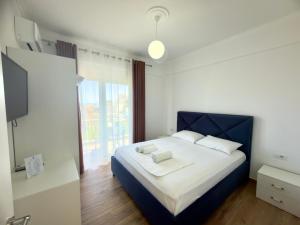 a bedroom with a bed and a large window at The Gwen in Sarandë