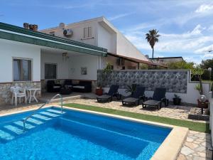 a villa with a swimming pool in front of a house at Villa Max in San Nicola Arcella