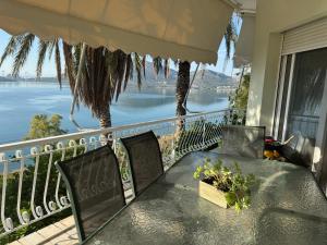 a table on a balcony with a view of the water at Elenas house in Kánithos