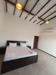a bedroom with a large bed in a room at Jesoloresort Arugambay in Arugam Bay
