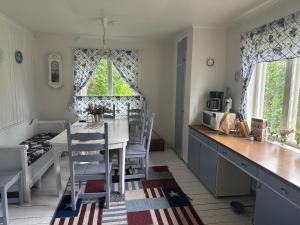 a kitchen and dining room with a table and chairs at Nordic Villa Undrom in Undrom