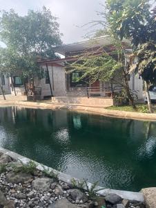 a pool of water in front of a house at บ้านนกฮูกรีสอร์ท in Ban Chamun (2) +7 photos